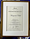 Margareta har tilldelats ett diplom för sin yrkesgärning.