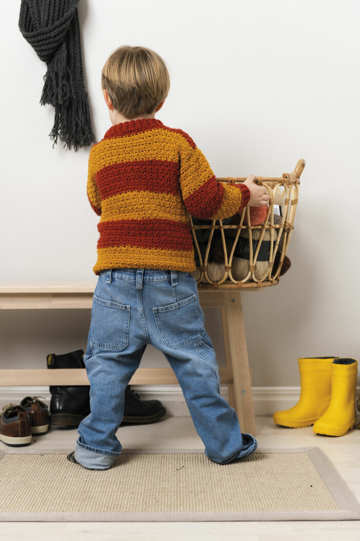 The shirt works just as well for a party as it does for a play date. Boy wearing a crochet sweater with stripes