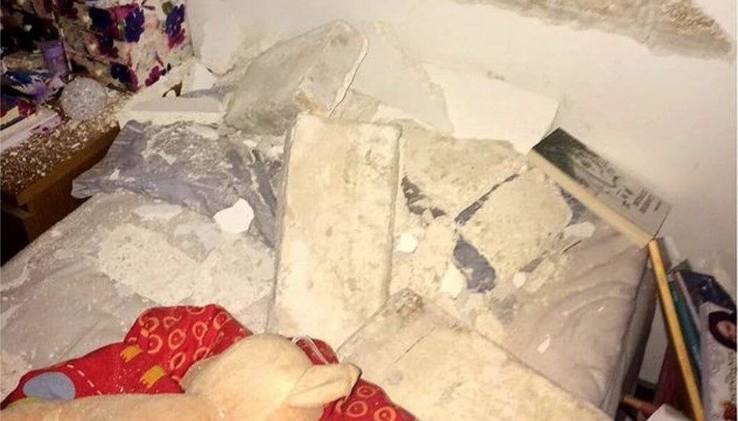 Sängen som den yngsta dottern sov i innan Anna slet upp henne. Tegelstenarna från väggen som strax efteråt rasade låg länge kvar bland flickans sängkläder, kuddar och nalle. Foto: Privat Dotterns säng efter jordbävningen.