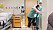 En gravid kvinna lutar sig framat mot en fonsterkarm i forlossningsrummet samtidigt som en barnmorska haller henne om ryggen