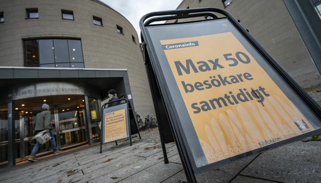 Max 50 besökare får vistas samtidigt inne på Malmö stadsbibliotek. En skylt utanför Malmö stadsbibliotek informerar om att max 50 besökare får vistas på biblioteket samtidigt.