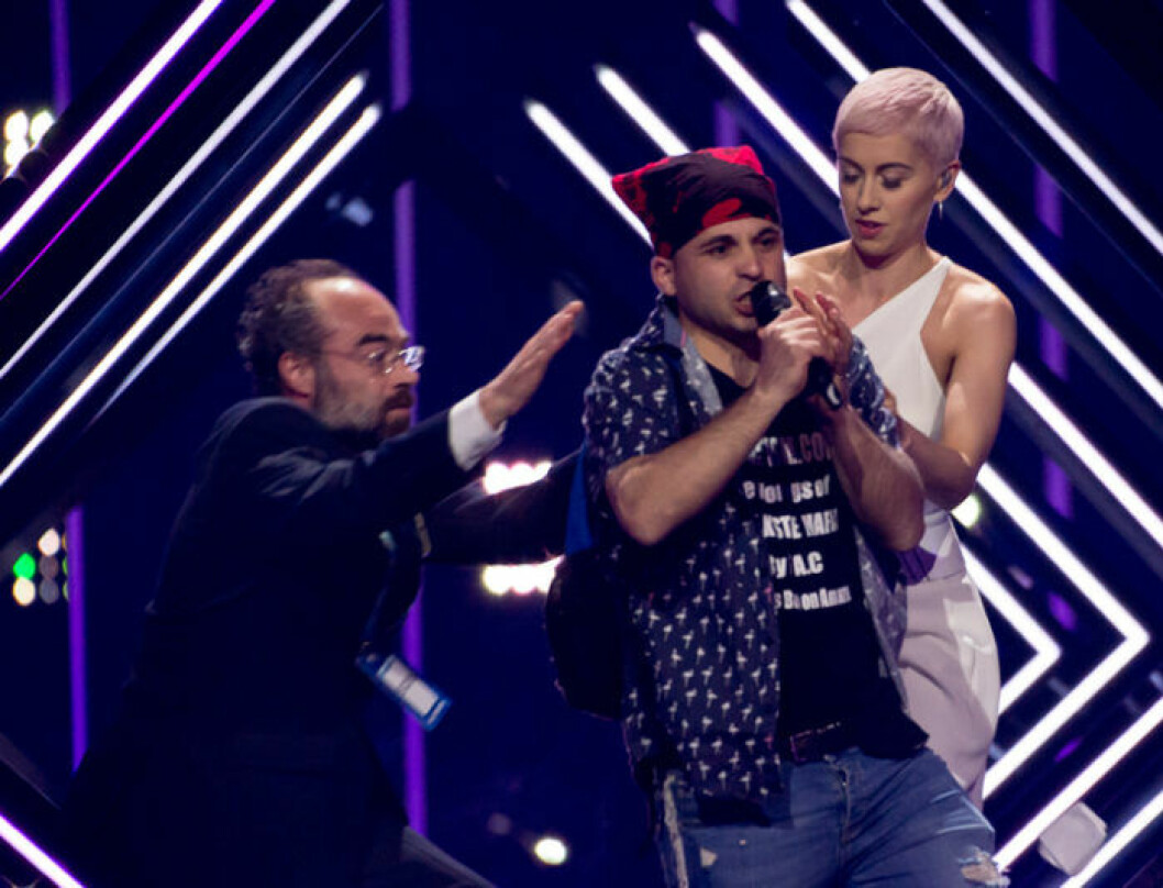 En man tog sig upp på scenen under <em>Eurovision Song Contest</em> och tog mikrofonen av brittiska Surie. Foto: IBL Bildbyrå En man tog sig upp på scenen under Eurovision Song Contest och tog mikrofonen av brittiska Surie.