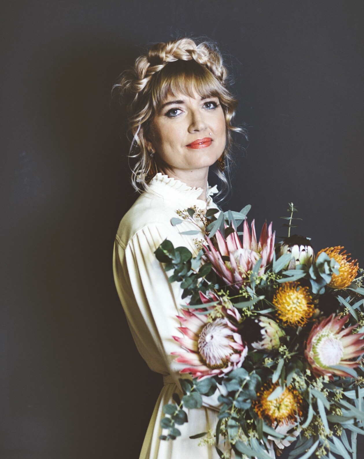 Blommor har en central roll i Holly Ringlands bok berättelsen om Alice Hart. Författaren Holly Ringland med en blomsterbukett i famnen.