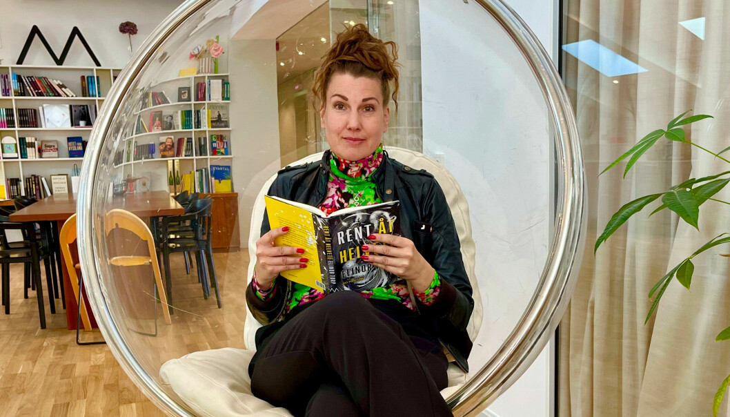 Författaren och journalisten Elinor Torp sitter med sin bok på Mondials kontor