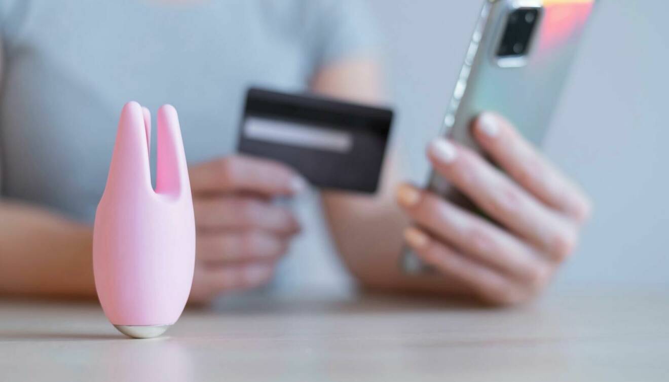 Kvinna med kreditkort handlar sexleksak på nätet.