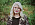 Porträttbild av Ida Högström. Hon har långt blont hår och är klädd i en leopardmönstrad kavaj samt bär stora glasögon.
