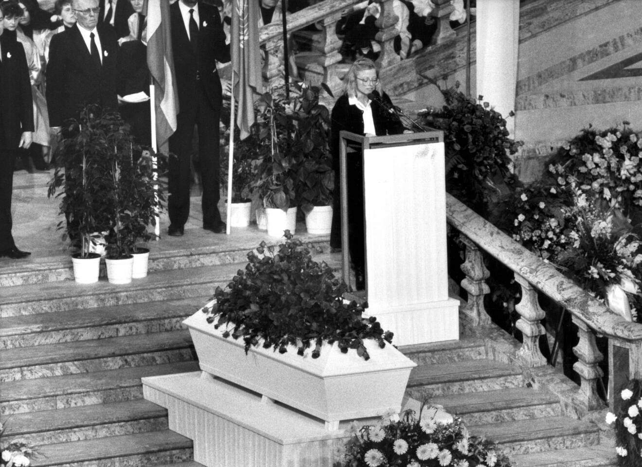 En svartvit bild från Olof Palmes begravning 1986. Anna Lindh håller tal.