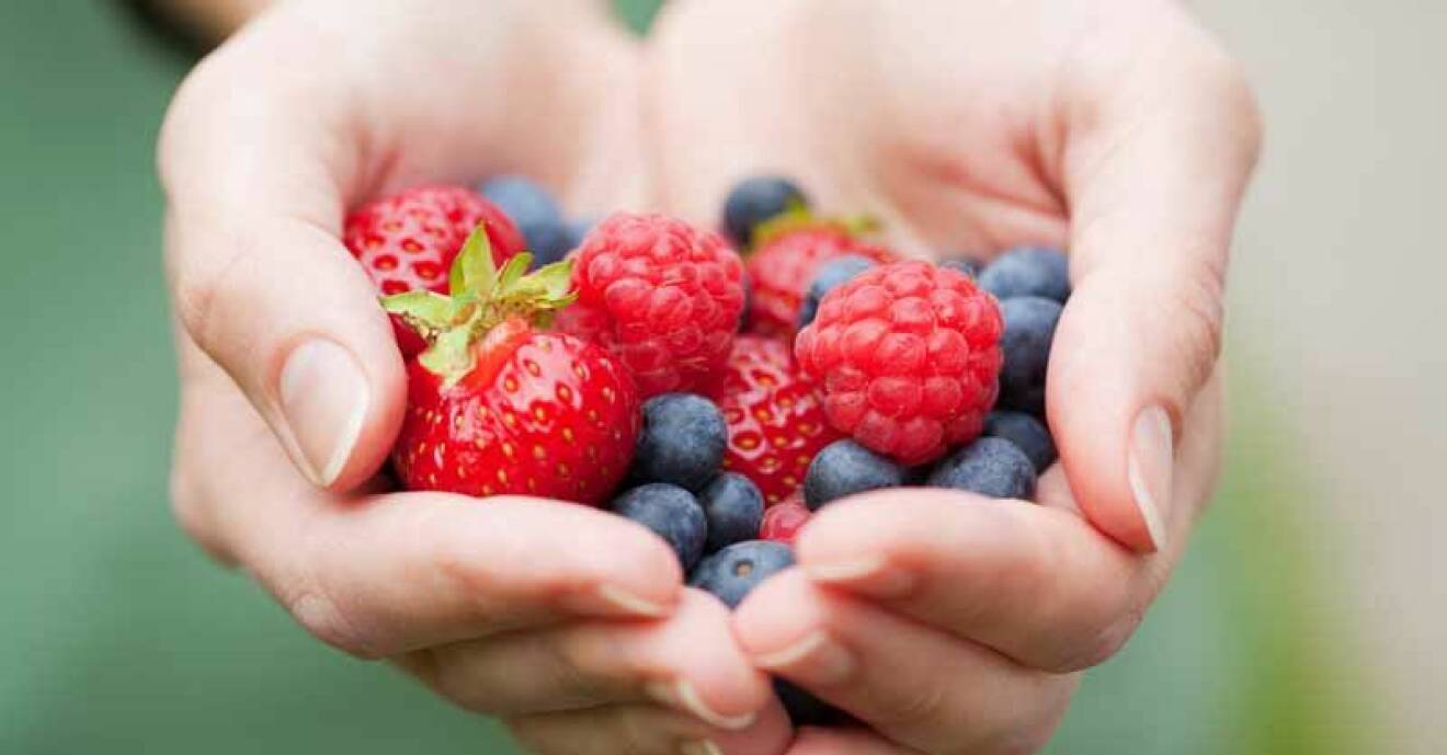 En handfull bär – jordgubbar, blåbär och hallon.