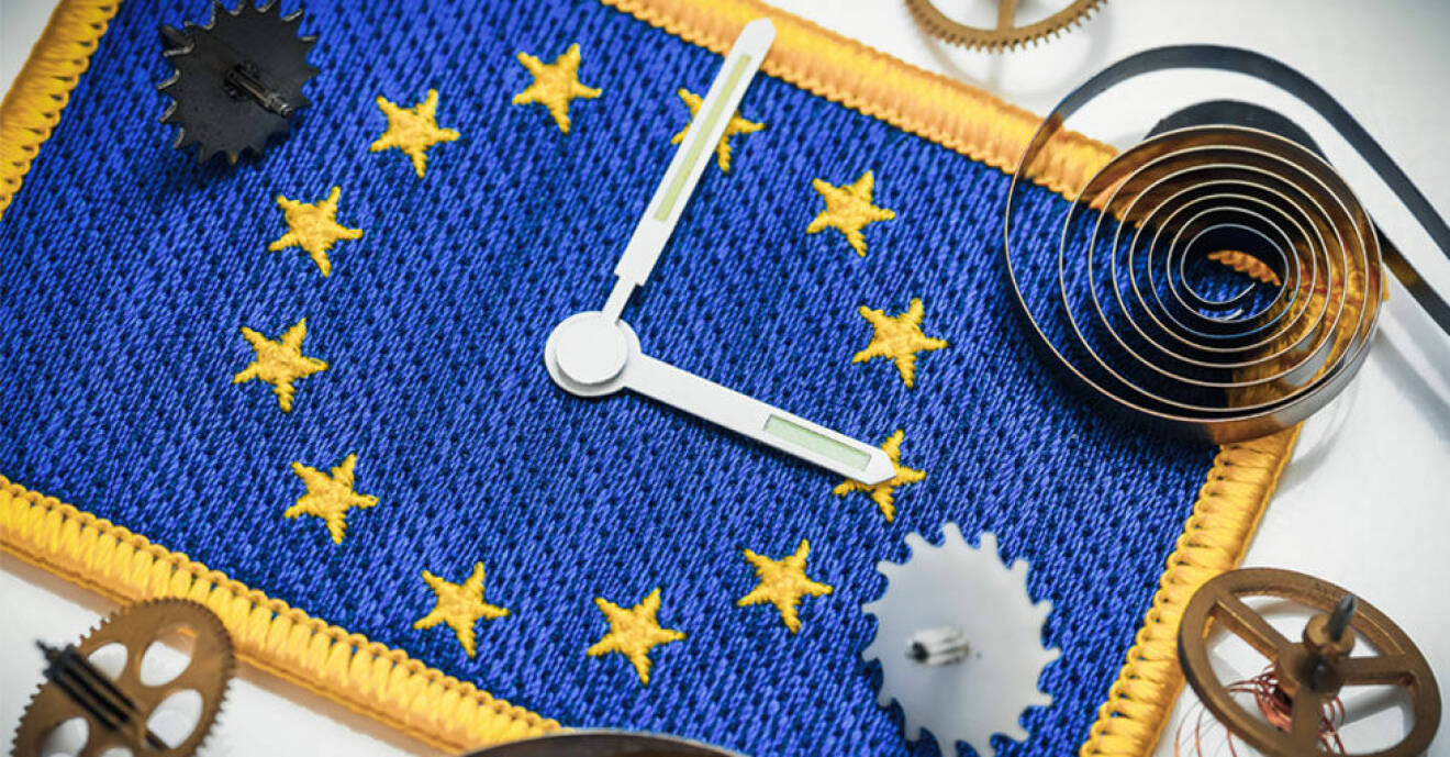 EU:s flagga som en klocka med två visare i mitten