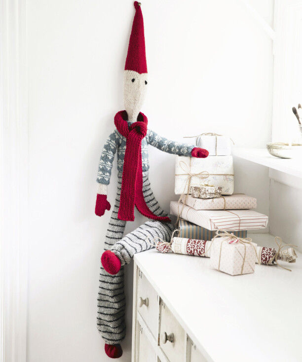 Det är både enkelt och roligt att sticka en fin jultomte. Stickad tomte fäst på väggen