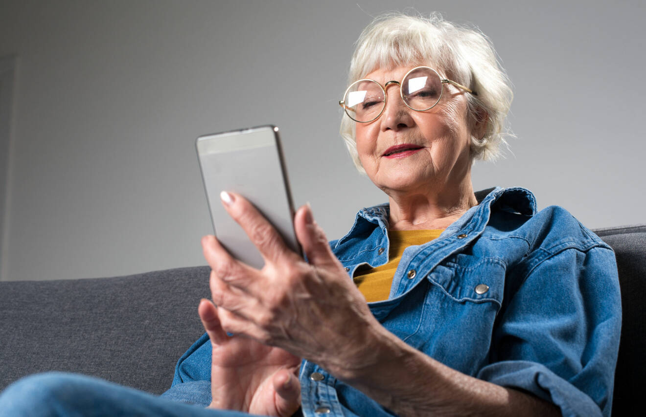 Kvinna, en så kallad Digitant, sitter och tittar på sin mobil.