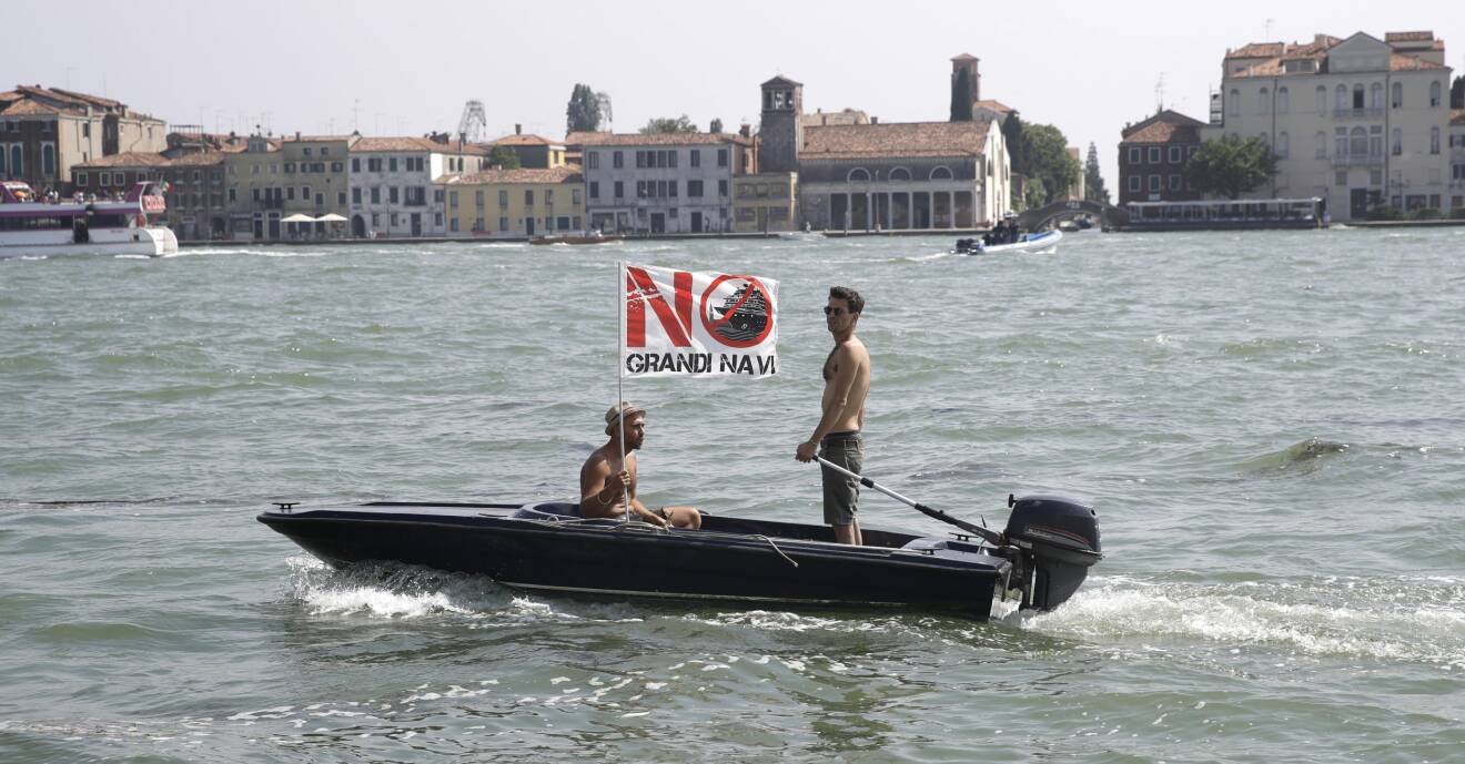 Aktivister protesterar mot kryssningsfartyg utanför Venedig i juni 2019 med en flagga med orden Inga stora fartyg på itelienska.