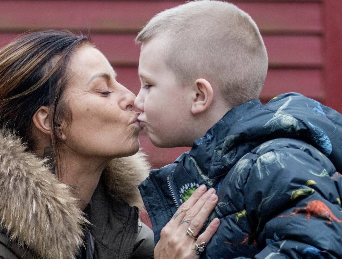 Mamma ger sin son en puss.
