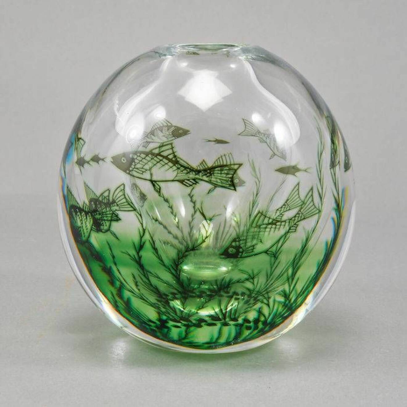 Fiskgraal i genomskinlig glas med gröna fiskar och växter av Edward Hald.