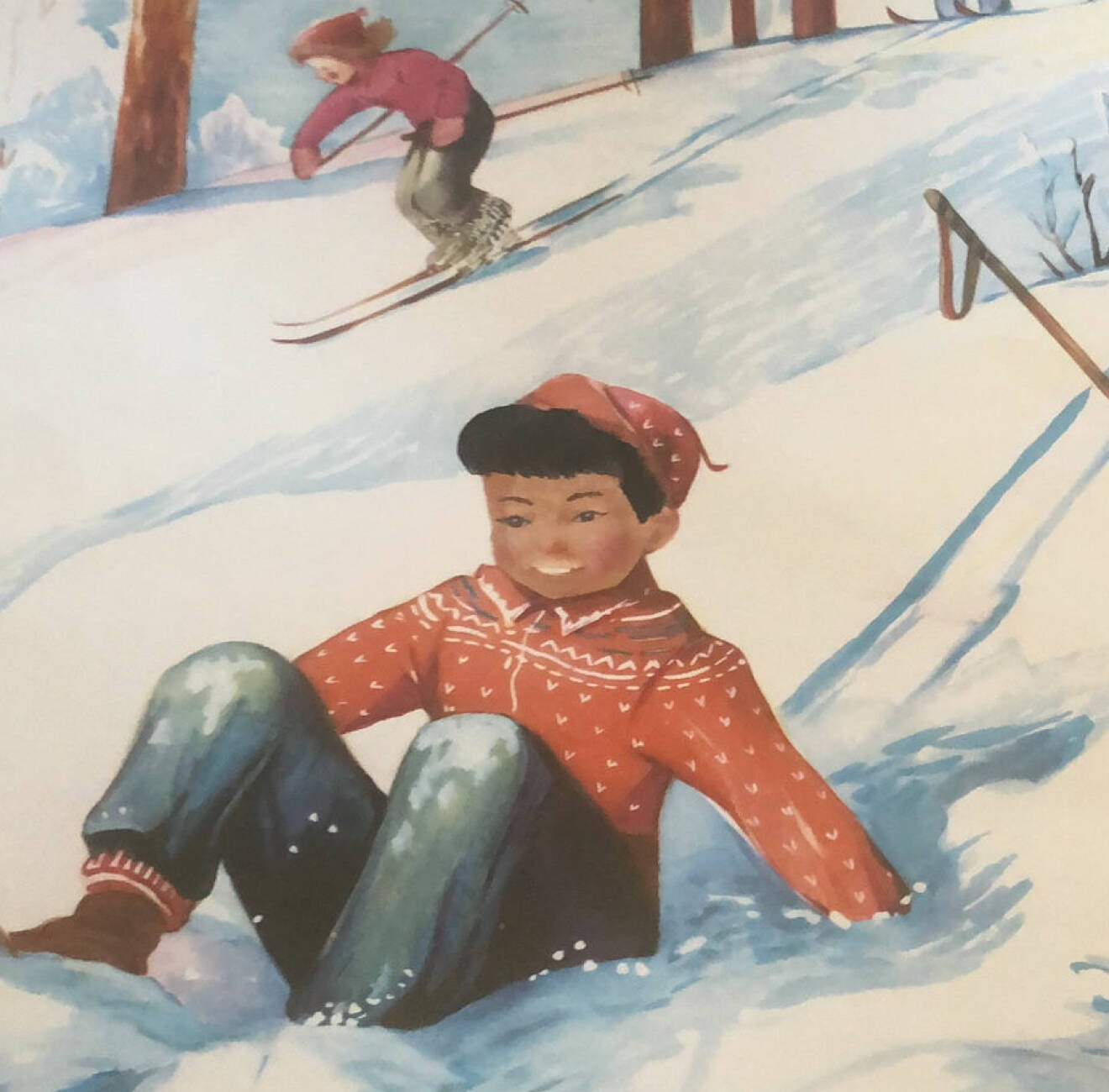 Ommålad kalenderbild. En pojke med brun hy har ramlat och sitter i en snöig backe. Bakom honom åker en flicka förbi på skidor.