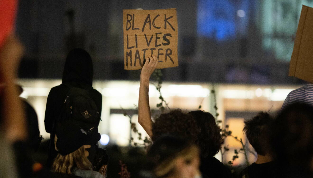 En skylt med texten Black lives matter hålls upp under en demonstration.
