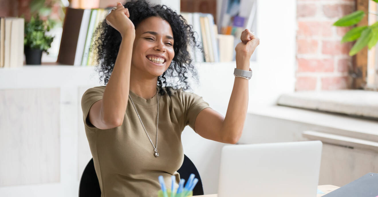 Kvinna med händerna i luften är glad framför en datorskärm. Vill du också vara glad när du betalar räkningarna? Då kan du göra några insatser för din ekonomi.