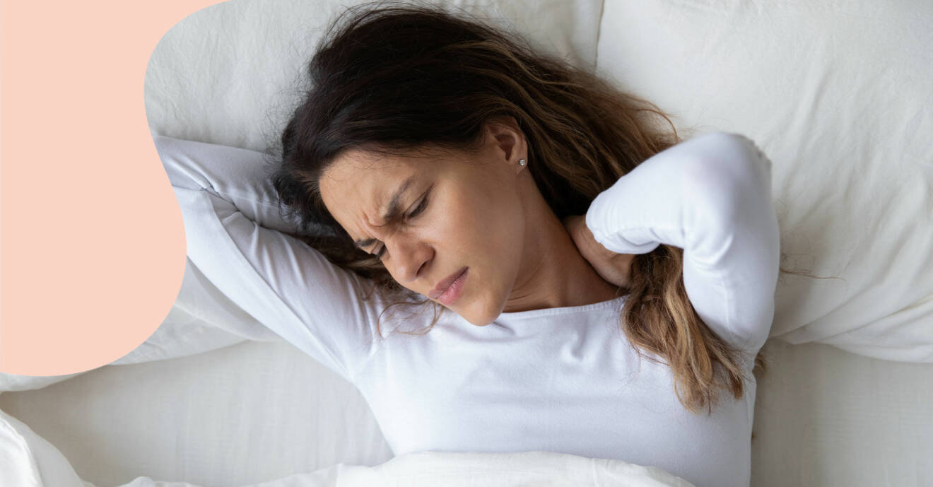 En kvinna ligger i sin säng och har nackspärr med tydlig smärta.