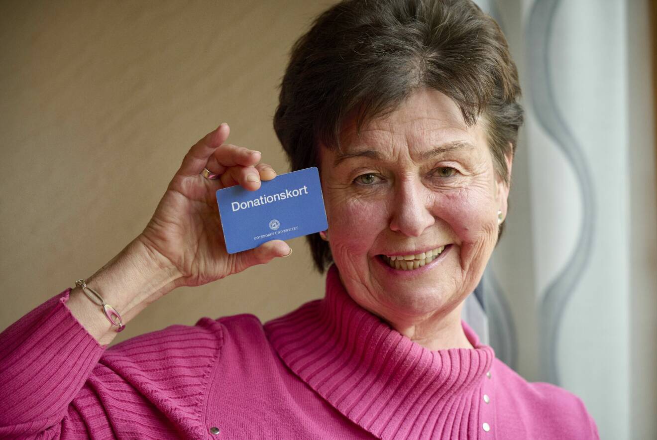 En leende Ann-Britt Sivnert håller upp sitt donationskort.