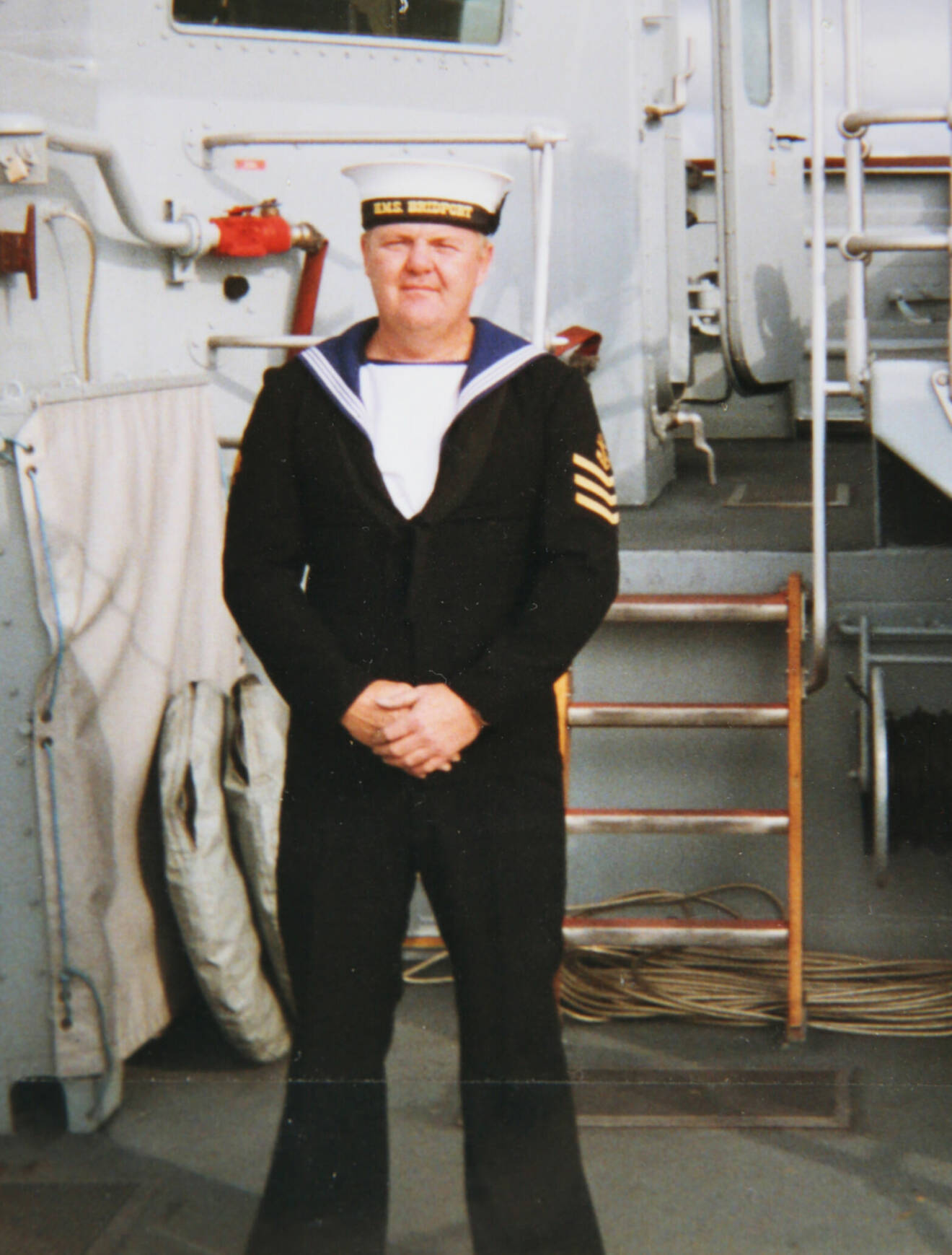 En man i 40-årsåldern i sjömanskläder på ett fartyg.