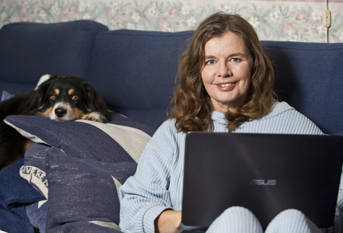 Jeanette jobbar gärna i soffan med sina texter, och ofta i sällskap av hunden Cody. Hon är fortfarande noga med att palla upp med kuddar för att avlasta ryggen. Författare Jeanette Bergenstav jobbar med sin bok i soffad uppallad med kuddar. Bakom henne vilar hunden Cody.