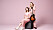 Johanna och Klara Söderberg i First aid kit med gitarr och förstärkare mot en rosa bakgrund.
