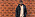 Loui Sand står mot en tegelvägg, han har på sig en beige tröja och en svart dunjacka.