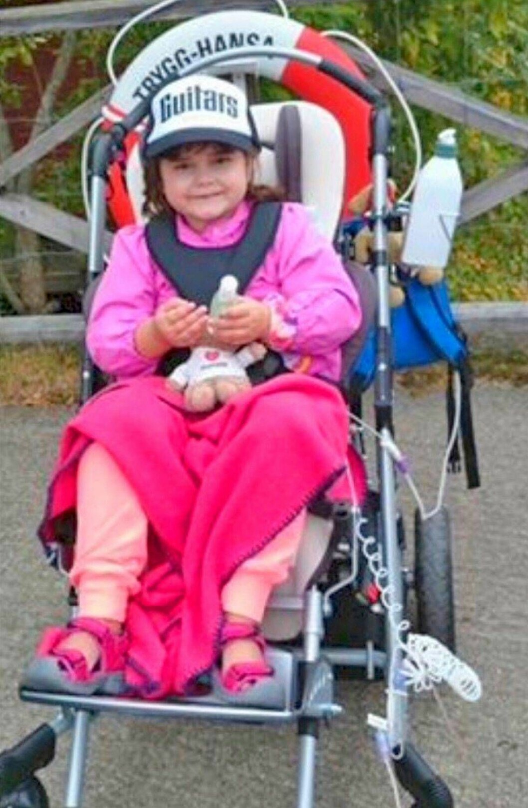 Ett stort hjärta i en liten kropp. Almina ville alltid skänka pengar till tiggare. Foto: Privat En liten flicka sitter i en sittvagn med en rosa filt över knäna.