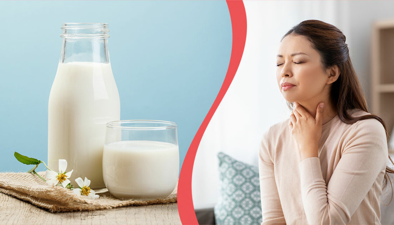 Kvinna som håller sig för halsen och ett glas mjölk