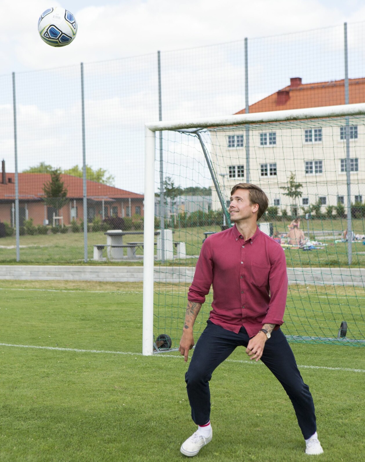 Takterna sitter i den forne fotbollslagkaptenen! Högstadieskolan i bakgrunden. Nils kickar fotboll på sin gamla hemmaplan.