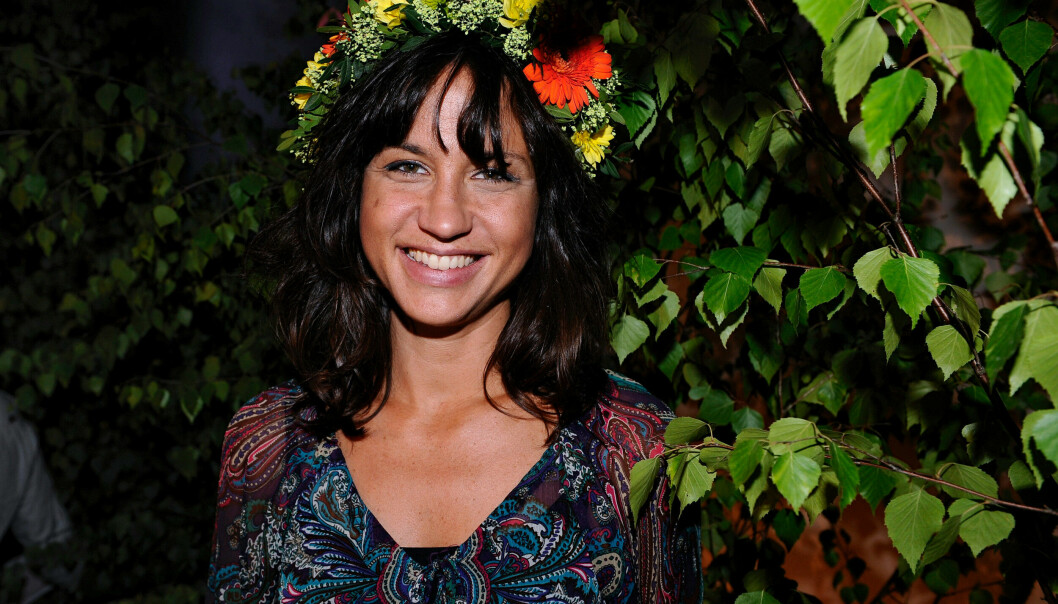Petra Mede sommarpratade och här på bilden syns på med en krans på huvudet.