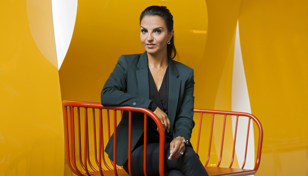 Shoka Åhrman brinner för att lära oss kvinnor hur viktigt det är att investera sina pengar för ett långsiktigt sparande. Sparekonomen Shoka Åhrman mot en gul bakgrund.